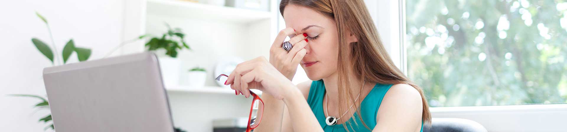 Woman grabbing forehead in frustration