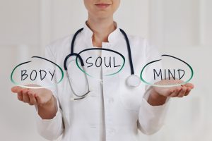 Doctor with palms facing up while the words mind, body, and soul are displayed above hands - Holistic solutions for sleep apnea