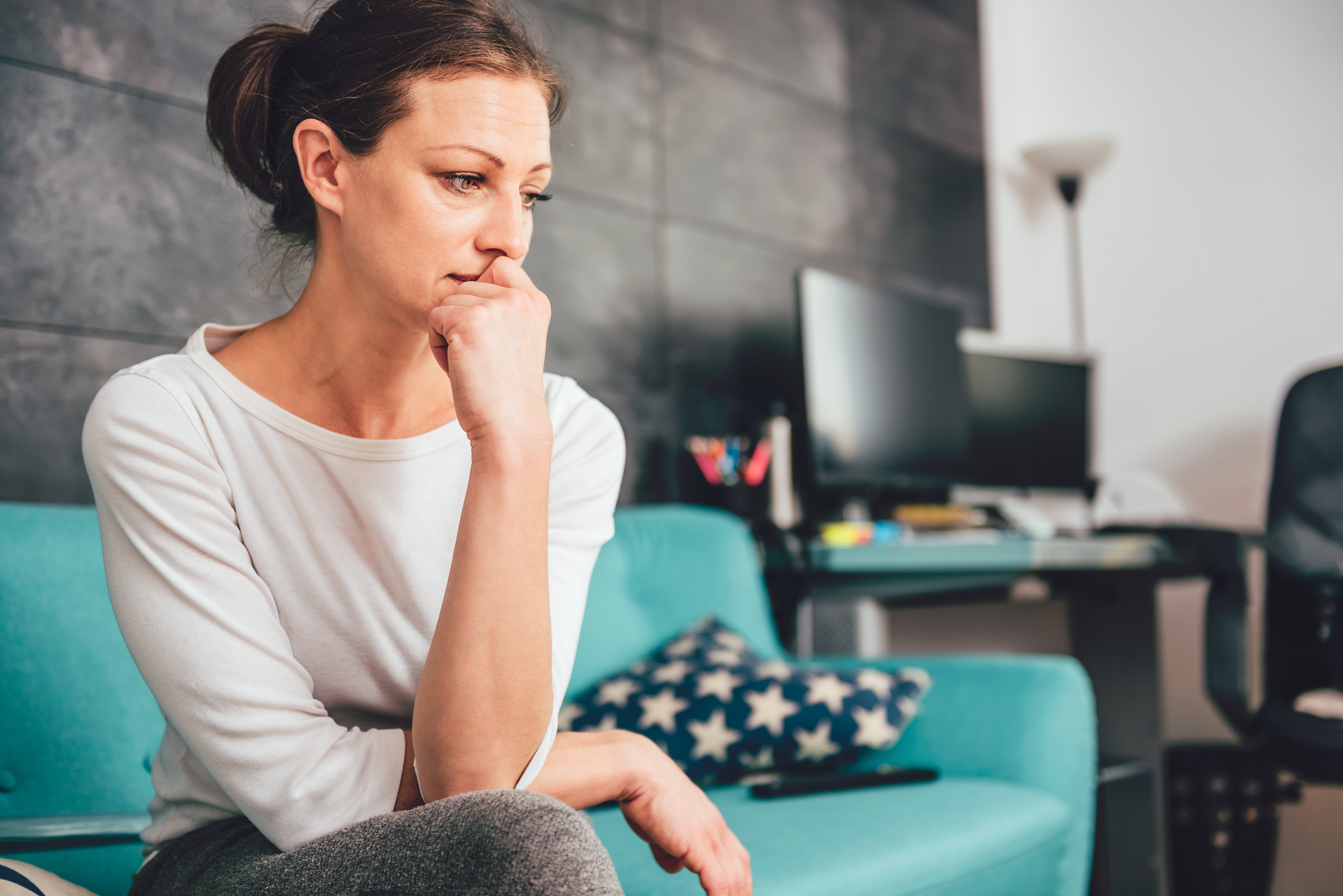 woman with anxiety sitting in an office - Can Sleep Apnea Cause Anxiety?