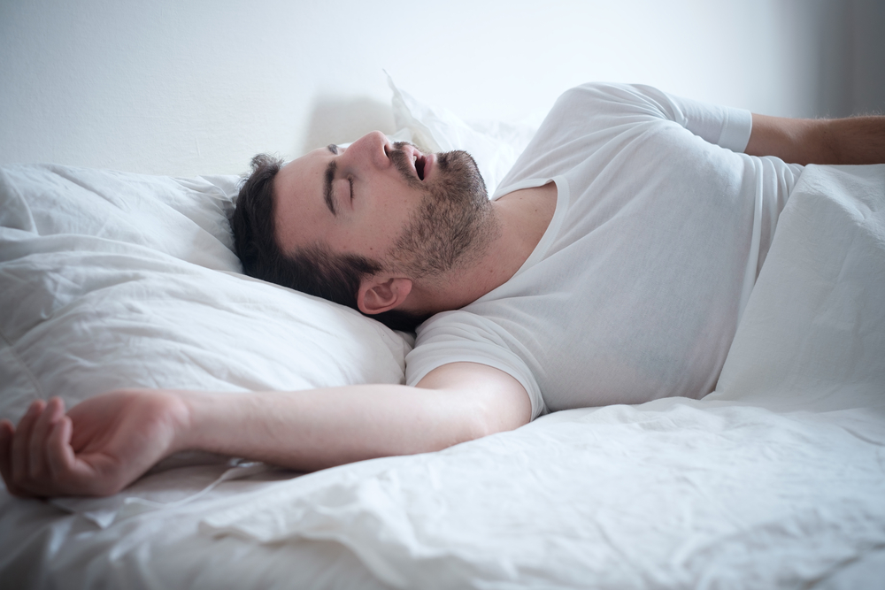 Man snoring in his bed / Sleep apnea treatment in Encino, CA
